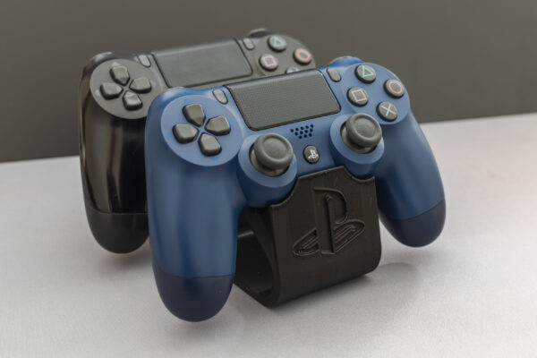 Side view of the black PlayStation controller stand showing the embossed PlayStation logo and curved ergonomic design