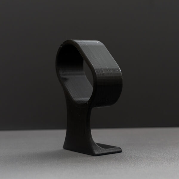 Alternative angle of the 3D-printed watch stand showing its construction details and matte black finish with visible print layers.